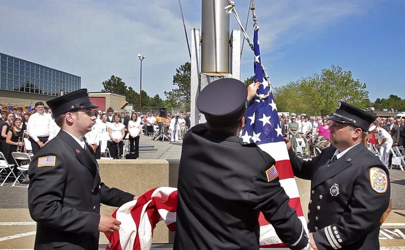 Firefighters at Brunswick Naval Air Station take down the flag for the last time at the base’s 2011 disestablishment ceremony. “Politics is getting in the way” of redevelopment, a reader says.
