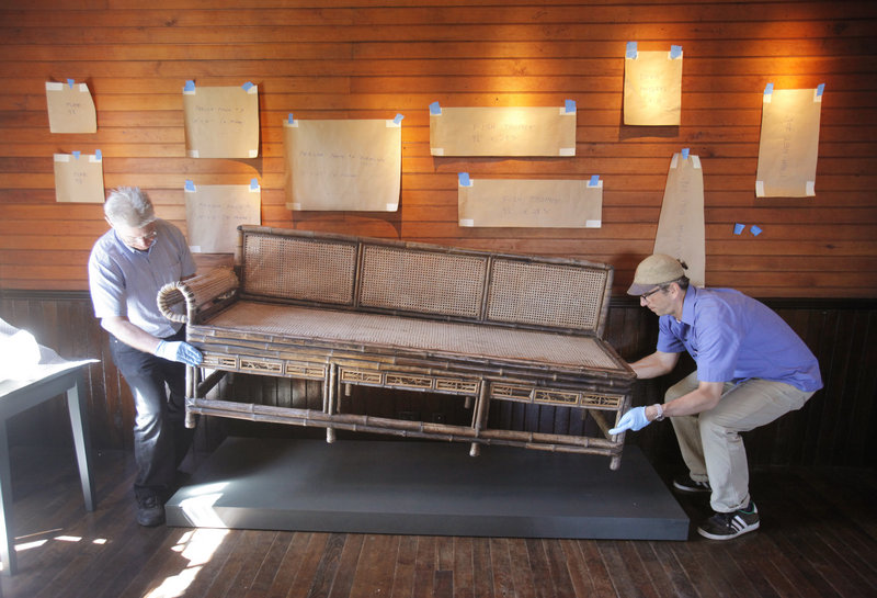 During the restoration, Greg Welch and Kris Kenow, preparators with the Portland Museum of Art, arrange pieces at Winslow Homer's studio at Prouts Neck this spring.
