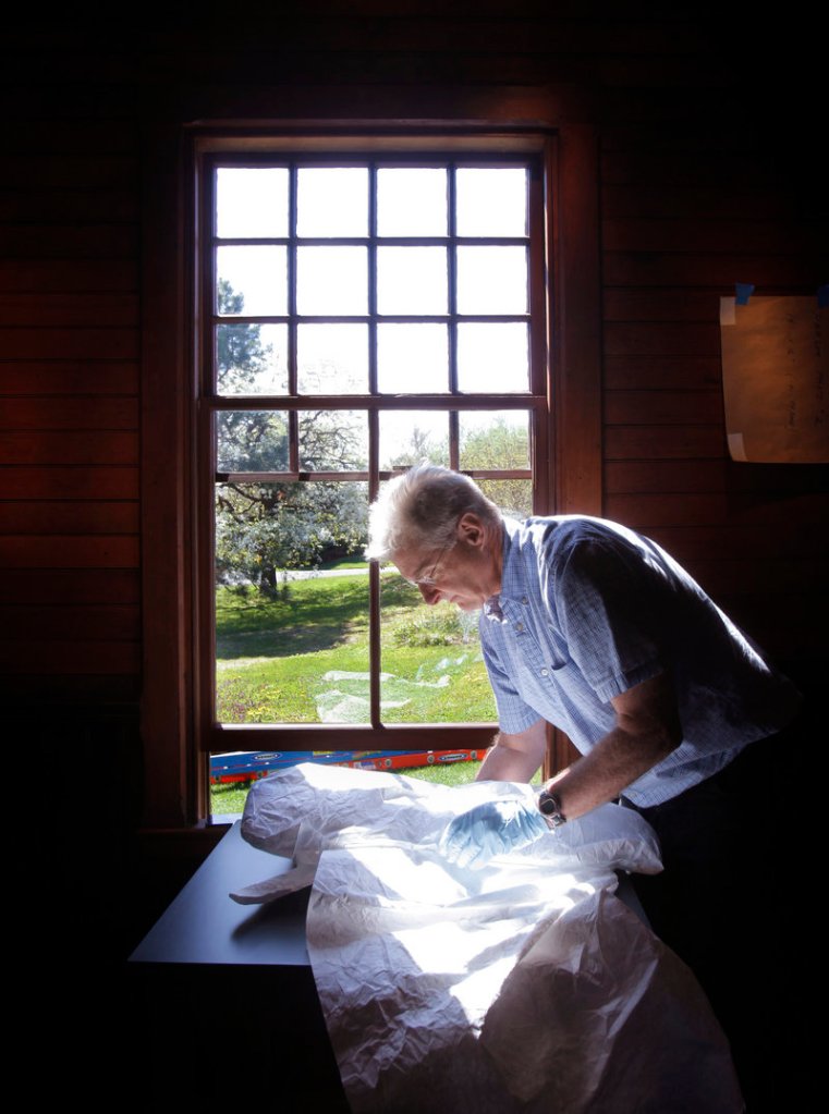 Greg Welch, chief preparator with the Portland Museum of Art, unwraps a piece to be exhibited at the Scarborough site, where Homer lived for parts of the year from 1883 until his death in 1910 at age 74.