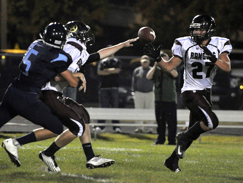 Svenn Jacobson takes a pitch Friday night as Greely looks for yardage during its 33-12 victory against Westbrook in a game between Western Class B unbeatens.