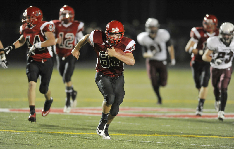 Charlie Raybine of Scarborough heads to the end zone Friday night, returning an interception 22 yards for a touchdown in the third quarter. The Red Storm improved their record to 3-0 with a 27-12 victory against Windham.