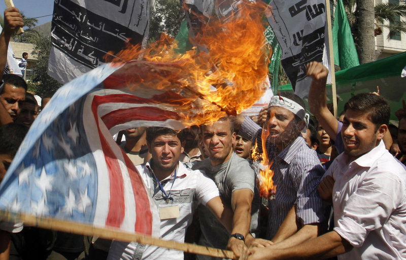 Palestinian Hamas supporters burn a U.S. flag during a protest in Gaza City, Friday, Sept. 14, 2012 as part of widespread anger across the Muslim world about a film ridiculing Islam's Prophet Muhammad. (AP Photo/Hatem Moussa)