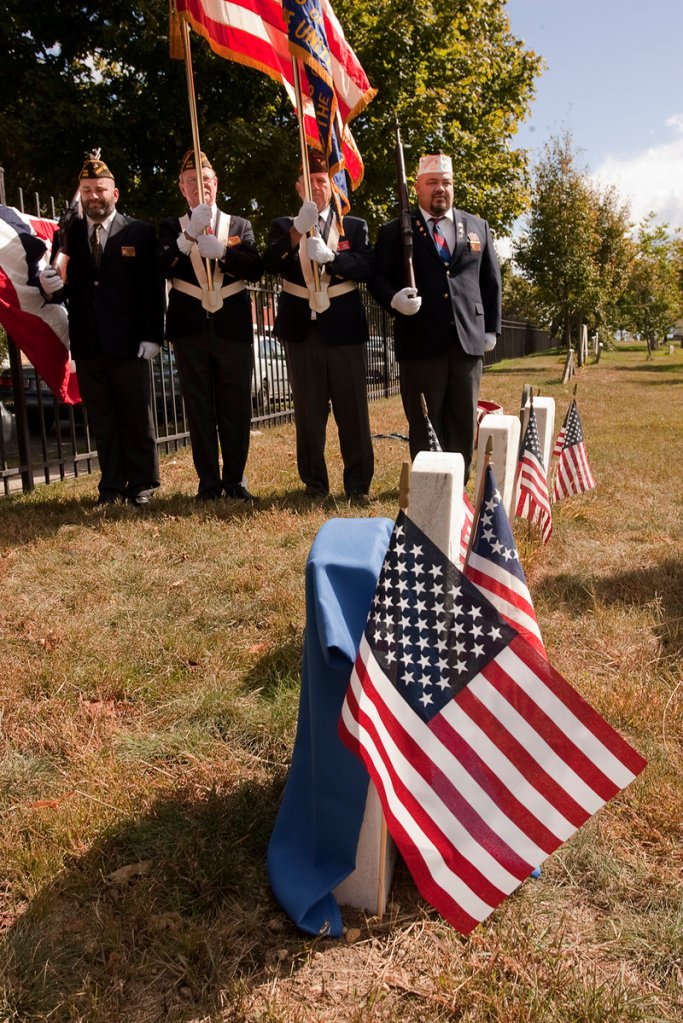 Members of the Deering Memorial Post 6859 Veterans of Foreign Wars honor Richard Hill, an African-American veteran of the War of 1812, at Eastern Cemetery in Portland on Saturday.