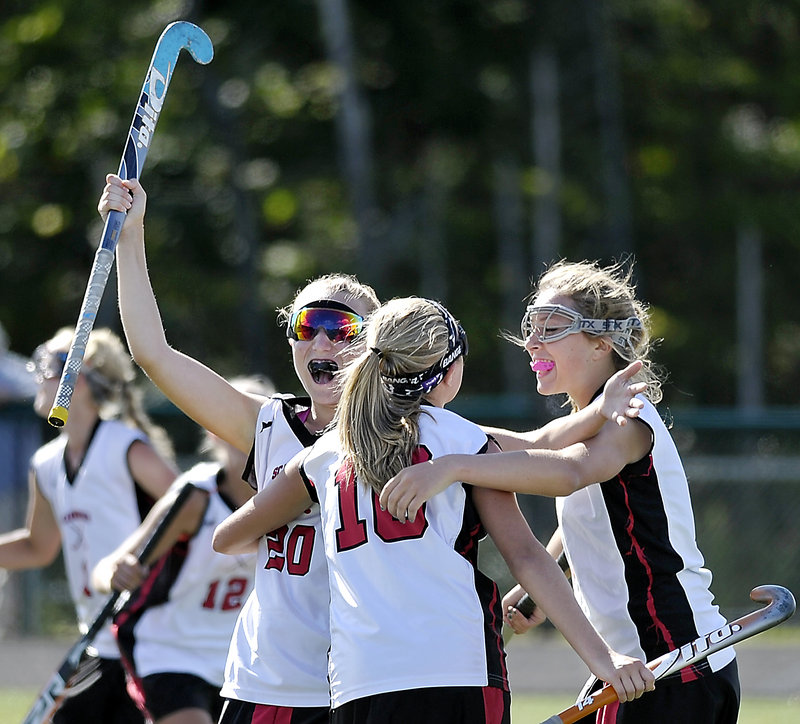 Grace Whelan, left, celebrates with Karli-An Gilbert, center, and Rose Kirsch after Whelan set up a goal by Emily Bunting that accounted for all the offense Saturday in Scarborough’s 1-0 field hockey victory over Marshwood