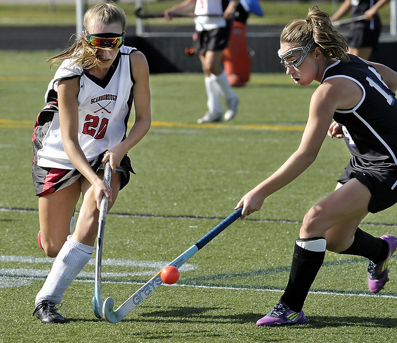 Grace Whelan, left, of Scarborough battles with Ashley Tice of Marshwood during a clash of unbeaten field hockey teams Saturday. Scarborough won, 1-0.