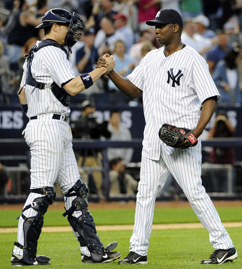 Yankees closer Rafael Soriano celebrates with catcher Chris Stewart after finishing off a 5-3 win over Tampa Bay that kept New York in first place in the AL East.