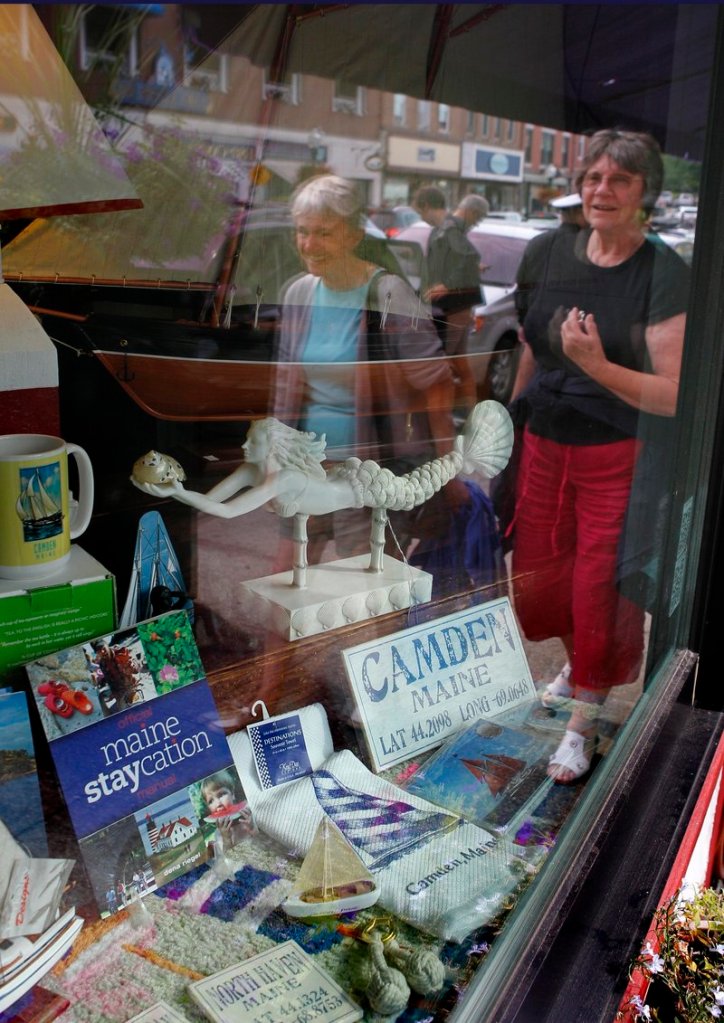 A book titled “Maine Staycation” sits on display in a storefront in Camden.