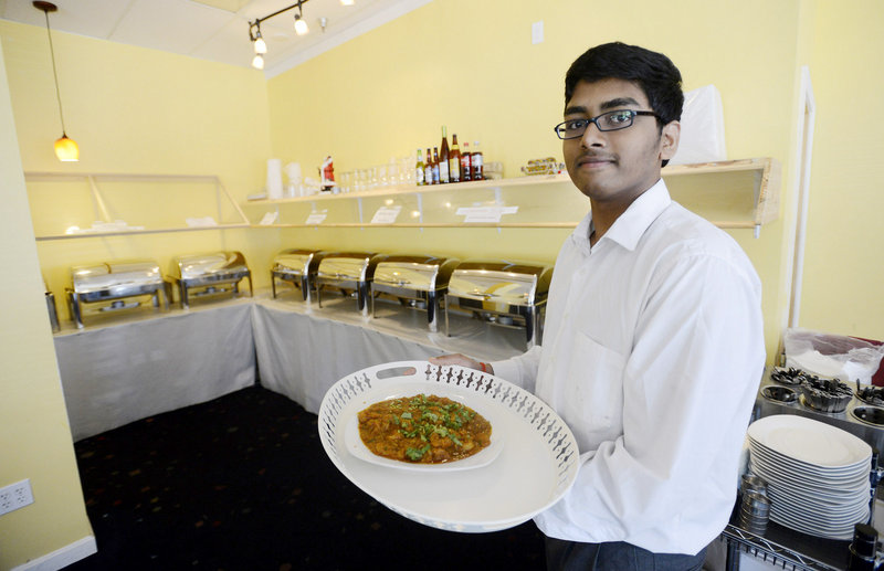Paul Guntaka shows off the Indian Shrimp Masala at Taj Indian and Indo Chinese Cuisine in South Portland.
