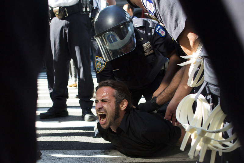 Occupy Wall Street protester Chris Philips screams as he is arrested near Zuccotti Park in New York City on Monday.