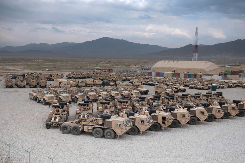 Various military vehicles sit parked after being cleaned and stripped of sensitive items for shipment as part of the drawdown of 23,000 U.S. troops by Sept. 30 at the Kandahar Air Field south of Kabul, Afghanistan. Containers are being staged at nine sites in the country.