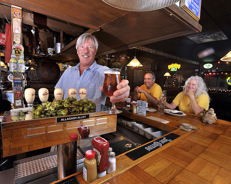 Peter and Kerrilyn Welch, reps for Chickadee Wines, are regulars and enjoy lunch at the Great Lost Bear as Mike Dickson, manager and bartender, draws an Allagash Victor.