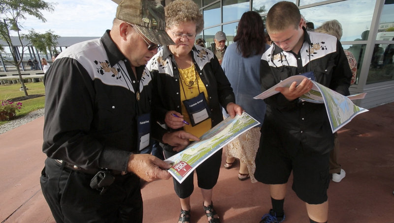 Howard and Merna Colwell and their grandson, Doug Mapes, left to right, look over maps of the city of Portland at the Ocean Gateway terminal after getting off a cruise ship on Tuesday, Sept. 18, 2012.