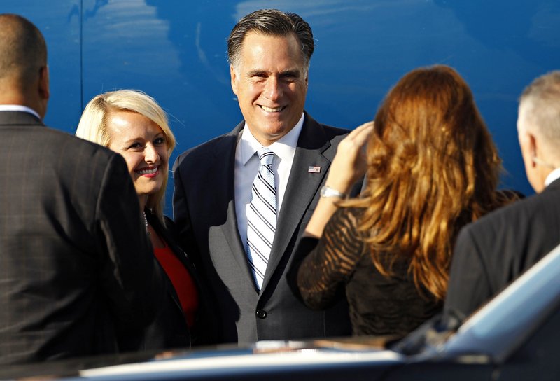 Republican presidential candidate Mitt Romney poses for pictures with supporters before boarding his campaign charter plane at Love Field in Dallas on Wednesday.