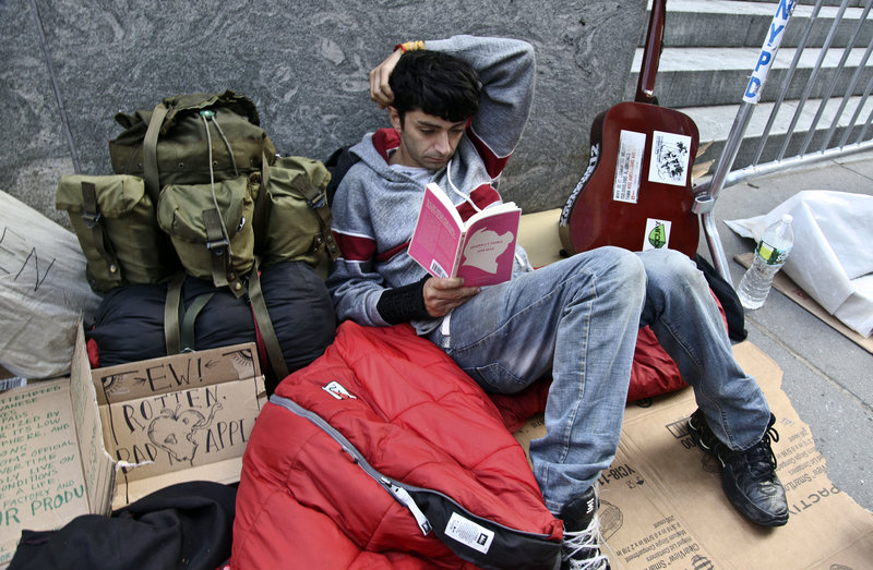 Joseph Cruz, 19, waits in line Thursday outside Apple’s Fifth Avenue store in New York City. Cruz, who started camping out last Friday, is not seeking easy cash or publicity – he just wants to get his hands on the new iPhone 5.