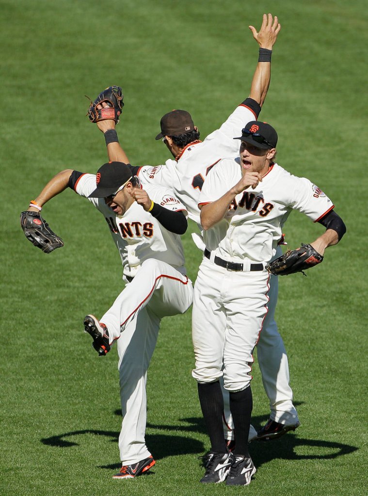 Giants outfielders Gregor Blanco, left, Angel Pagan and Hunter Pence celebrate after a 9-2 home win Thursday against the Colorado Rockies.