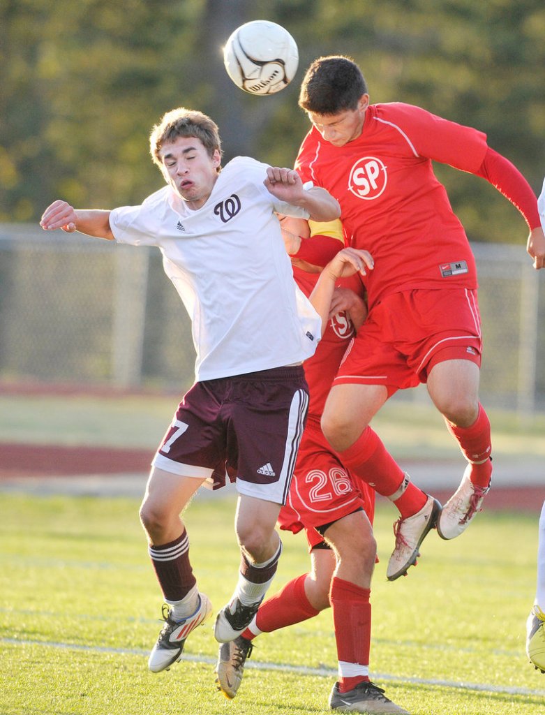 Marc Reynolds of Windham, left, competes with Adam Helmke of South Portland for the ball Thursday night during Windham’s 2-1 victory in an SMAA boys’ soccer match at South Portland.