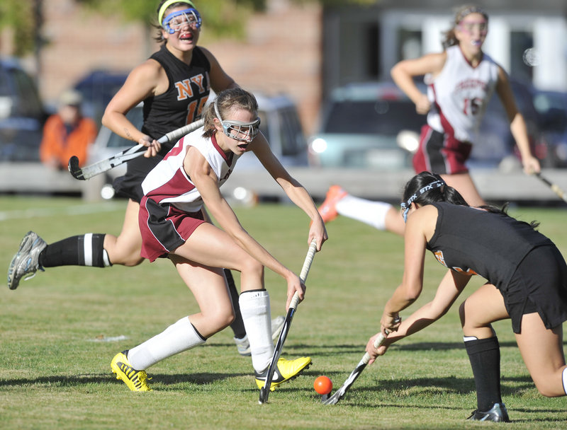 Olivia Bubar of Freeport, left, attempts to push the ball past Jen Brown of North Yarmouth Academy during NYA’s 5-1 field hockey victory Thursday.