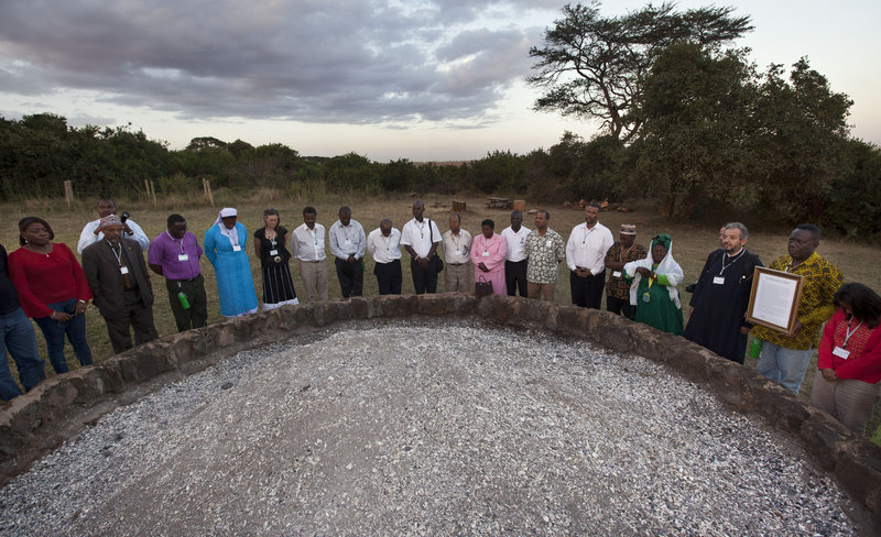 Religious leaders of different faiths pray Thursday around a pile of charred elephant ivory at a site in Nairobi National Park where Kenyan officials burned hundreds of ivory tusks in 1989 to draw attention to the slaughter of elephants.