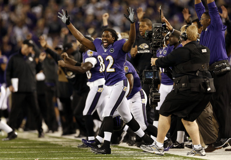 Torrey Smith, who caught two touchdown passes for the Ravens, celebrates after Justin Tucker kicked a 27-yard field goal as time expired to give Baltimore a 31-30 win Sunday night over the Patriots.