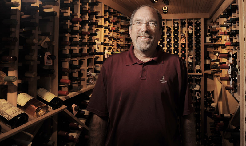 Eric Smith in the state-of-the-art wine cellar he had built in the basement of his South Portland home. Below, the Italian section.