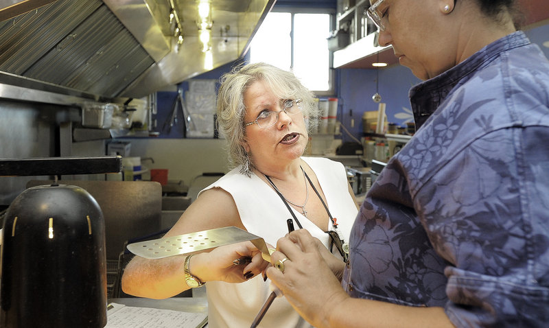 Portland health inspector Michele Sturgeon, left, talks with executive chef Cheryl Lewis in El Rayo Taqueria’s kitchen during inspection Monday. The city admits it lacks the resources to inspect restaurants on a regular basis.