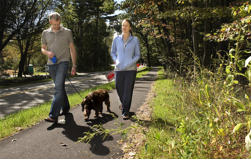 Daniel and Allison Poteet of Cape Elizabeth walk their field spaniel, Coco, along the Shore Road Path on Monday, Sept. 24, 2012. The two-mile path connects the Cape Elizabeth town center to Fort Williams, and is nearing completion.
