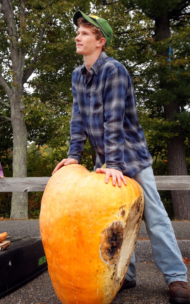 Lucas with his pumpkin. Al Berard of the Maine Pumpkin Growers Organization estimates that less than 50 percent of first-time growers successfully grow a giant and get it to a weigh-in without rot or some other problem cropping up.