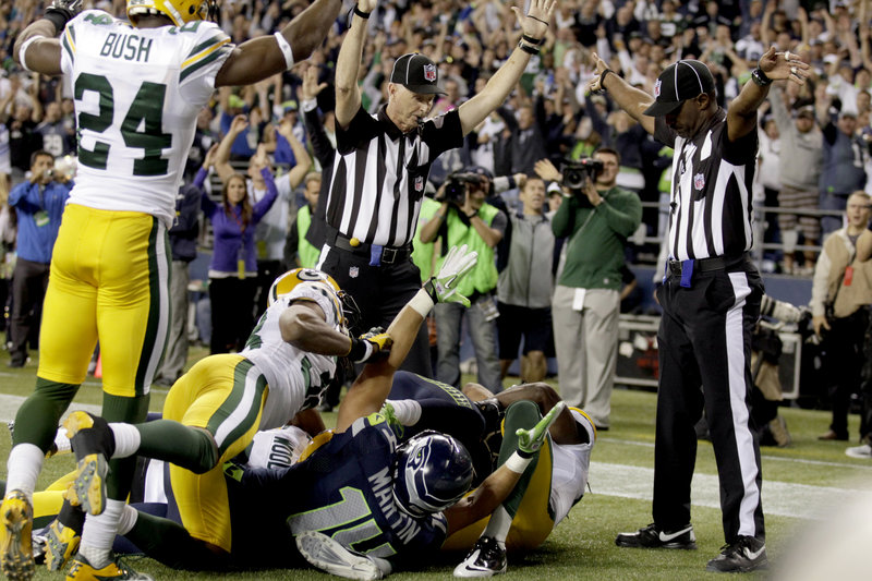 Officials appear to give conflicting signals on the final play of the Monday Night Football game between the Seattle Seahawks and the Green Bay Packers. The controversial call rewarded the Seahawks with a touchdown and the victory, 14-12.