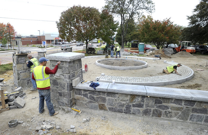 Employees from Saco-based Maineway Landscaping & Excavating construct a new entrance at Mill Creek Park in South Portland on Wednesday.