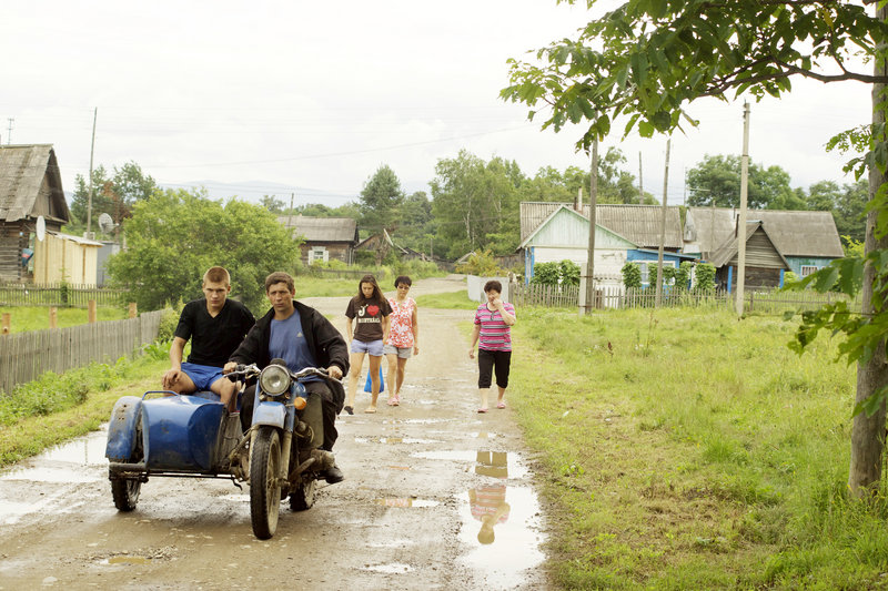 A motorcycle with a sidecar drives through Krasny Yar, a village of 680 people in the Russian Far East.