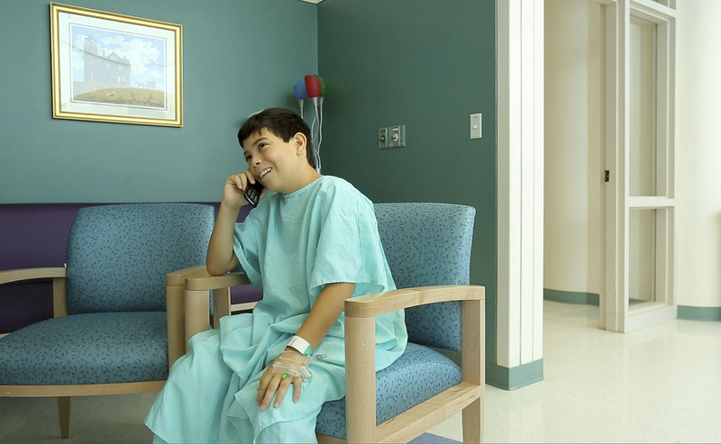 Jose talks on the phone with a family friend on Wednesday while recuperating at the hospital.