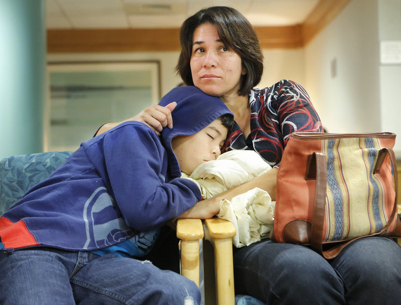 Rina Galan holds her 12-year-old son, Jose Marroquin Galan, while waiting for his chest to be X-rayed at Maine Medical Center in Portland, the day before his heart surgery on Sept. 21. They traveled from El Salvador so Jose could have his life-threatening heart defect corrected.