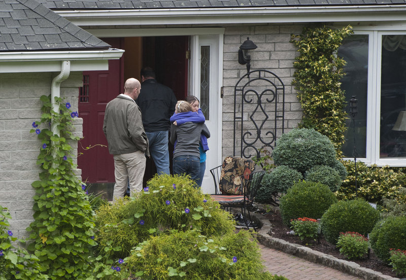 Visitors arrive at the home of Jeffrey Giuliano in New Fairfield, Conn., on Friday. Giuliano fatally shot a masked teenager during what appeared to be an attempted burglary Thursday, then discovered that he had killed his son, Tyler.
