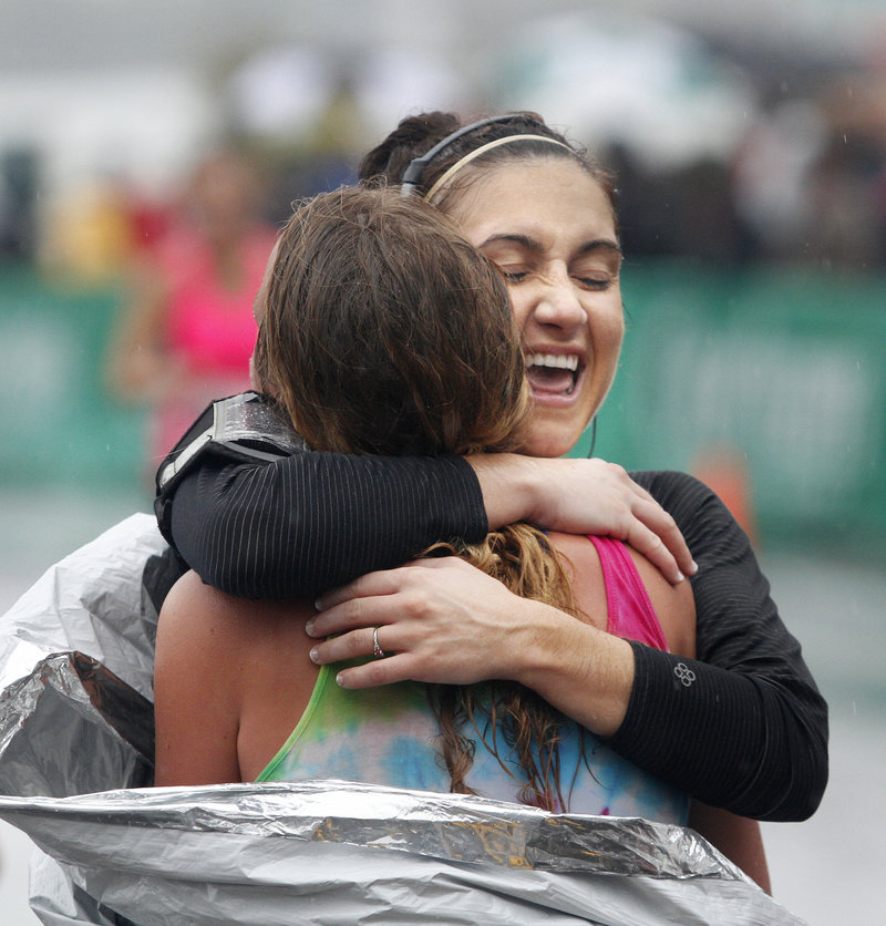 Amanda Byrne of Winslow receives a big hug from her friend and fellow runner, Ellen Sherwood of Augusta after finishing the half marathon course.