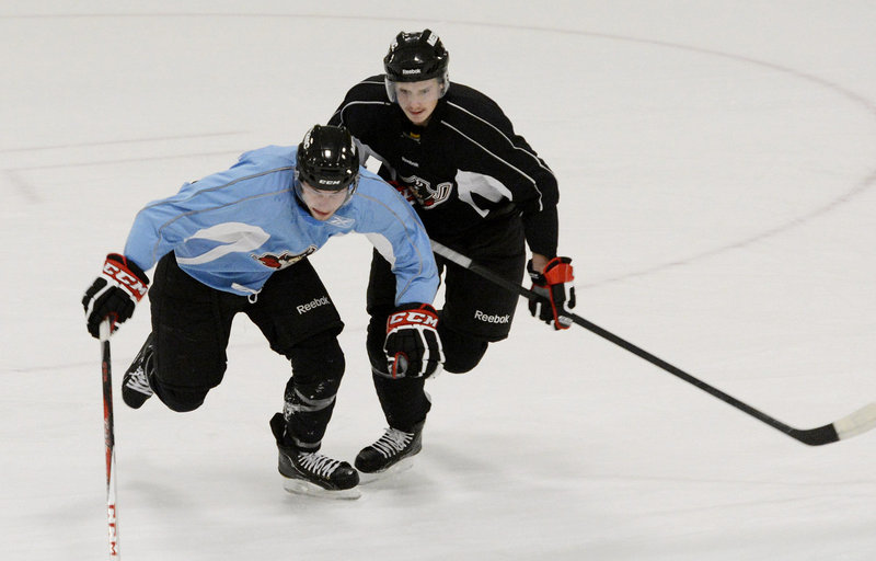 Oliver Ekman-Larsson, right, competes with Scott Arnold during drills Sunday at the Portland Pirates’ training camp at the Portland Ice Arena.