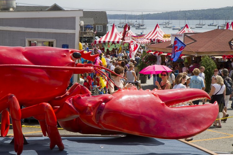 In this August 2011 file photo, the crowd funnels into Rockland's Annual Lobster Festival, past a giant crustacean. Two cruise lines have agreed to buys thousands of pounds of lobster from Ready Seafood in Portland when visiting Maine.