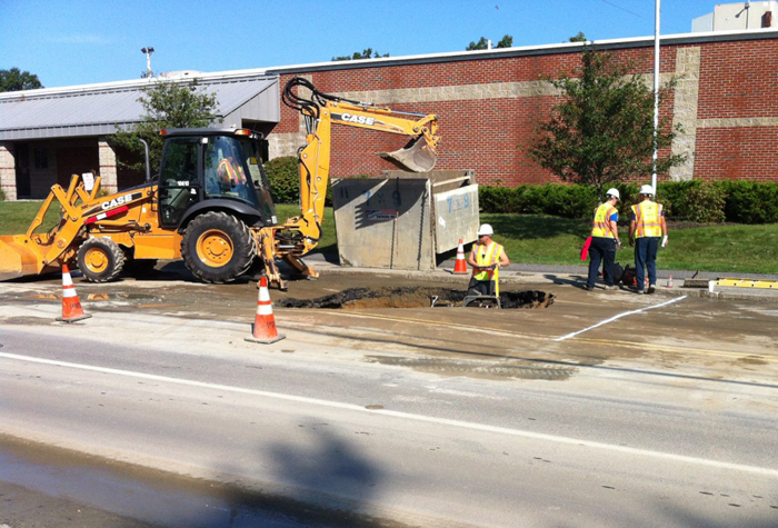 A Portland Water District Crew repairs a water main break on Broadway in South Portland on Friday.