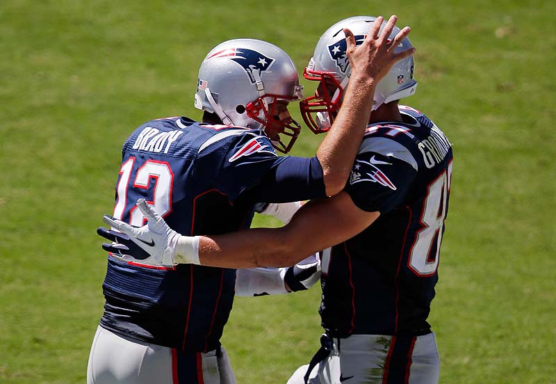 Patriots quarterback Tom Brady, left, celebrates with tight end Rob Gronkowski after throwing a 2-yard touchdown pass in the second quarter Sunday in Nashville, Tenn. The Patriots won, 34-13.