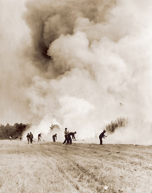 A line of volunteers tries to hold back the flames in a field in Biddeford Pool. In all, more than 250,000 acres burned across the state in the 1947 inferno.