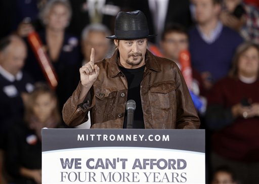 FILE - This Oct. 8, 2012 file photo shows recording artist Kid Rock speaking before introducing Republican vice presidential candidate, Rep. Paul Ryan, R-Wis., at a rally at Oakland University in Rochester, Mich. Dozens of celebrities, elected officials, and others are blitzing through battleground states in the White House race�s final days. Their goal: give the presidential campaigns a daily presence in key states even when the men at the top of the ticket (and their running mates) pitch for votes elsewhere. (AP Photo/Paul Sancya, File)