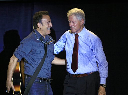 FILE - In this Oct. 18, 2012 file photo, former President Bill Clinton greets singer/songwriter Bruce Springsteen at a campaign event for President Barack Obama, in Parma, Ohio. Dozens of celebrities, elected officials, and others are blitzing through battleground states in the White House race�s final days. Their goal: give the presidential campaigns a daily presence in key states even when the men at the top of the ticket (and their running mates) pitch for votes elsewhere. (AP Photo/Tony Dejak, File)
