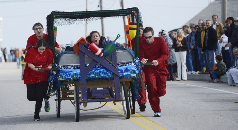 From left, Michael Thomas, Crystal Martin, Allyson Cavaretta, Jeremy Tripp and Chris Forrest of the team "Lobster Rolls" push their bed down Beach Street during the Bridge to Beach Bed Race in Ogunquit Sunday. The team was raising money for the Animal Welfare Society.
