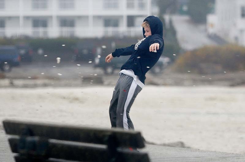 Thomas Beecher, 13, of York is held up by the wind at Short Sands Beach, Monday, Oct. 29, 2012, as the area began to see effects of Hurricane Sandy.