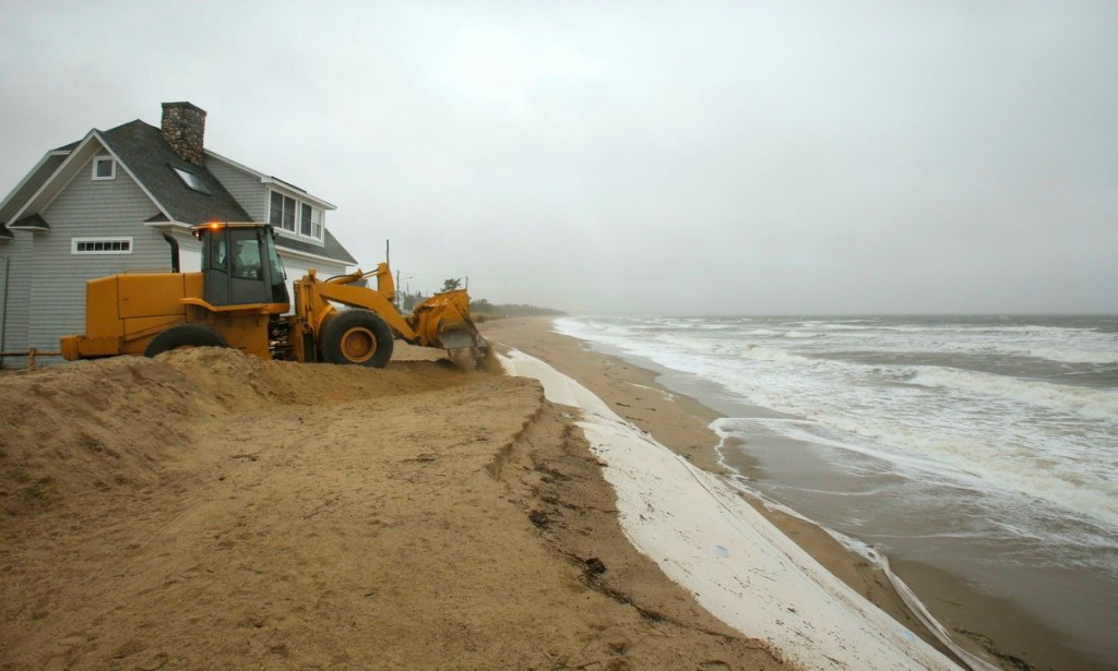 At the end of Fairhaven Avenue in Saco on Monday, October 29, 2012, a payloader builds up a dirt berm to protect the street from erosion expected to happen because of the storm surge hitting the coast from hurricane Sandy.