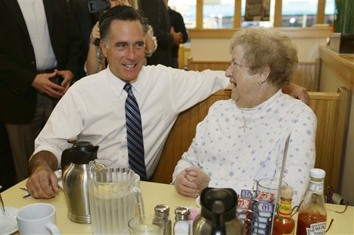 Republican presidential candidate, former Massachusetts Gov. Mitt Romney sits and talks to a customer as he makes an unscheduled stop at First Watch cafe in Cincinnati, Ohio, Thursday, Oct. 25, 2012. (AP Photo/Charles Dharapak)