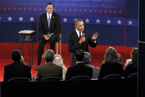 Republican presidential candidate former Massachusetts Gov. Mitt Romney, left, listens as President Barack Obama answers a question from a member of the audience during the second presidential debate at Hofstra University, Tuesday, Oct. 16, 2012 Hempstead, N.Y. (AP Photo/Mary Altaffer)