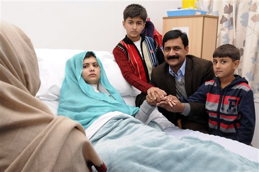 In photo issued by Queen Elizabeth Hospital, in Birmingham, England, on Friday, Malala Yousufzai poses with her father Ziauddin, and her two younger brothers, Atal, right, and Khushal.