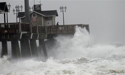 Large waves generated by Hurricane Sandy crash into Jeanette's Pier in Nags Head, N.C., on Saturday, Oct. 27, 2012 as the storm moves up the East Coast. Hurricane Sandy, upgraded again Saturday just hours after forecasters said it had weakened to a tropical storm, was expected to make landfall early Tuesday near the Delaware coast, then hit two winter weather systems as it moves inland, creating a hybrid monster storm.