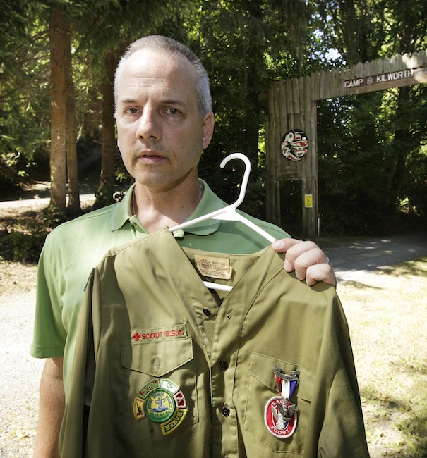 In this Thursday, Aug. 16, 2012 file photo, Boy Scout abuse victim Tom Stewart poses for a photo with his old Scout uniform outside the Boy Scout Camp Kilworth in Federal Way, Wash. "There are so many victims who have suffered in silence. Marriages and relationships with their kids have suffered," said Stewart, a 46-year-old engineer for Boeing. (AP Photo/Ted S. Warren)