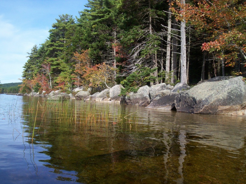 Large boulders line the shore in many places at Donnell Pond – located about 12 miles east of Ellsworth via Route 1 in one of Maine’s Public Reserved Lands – and some boulders are perched right in the water.